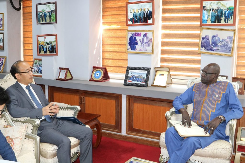 Two officials seated during a formal meeting; supplied file photograph